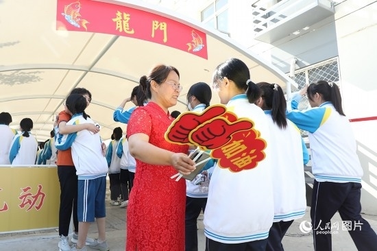 6月7日一早，雄安新區(qū)安新中學(xué)老師在給同學(xué)們加油鼓勁兒。人民網(wǎng) 李兆民攝