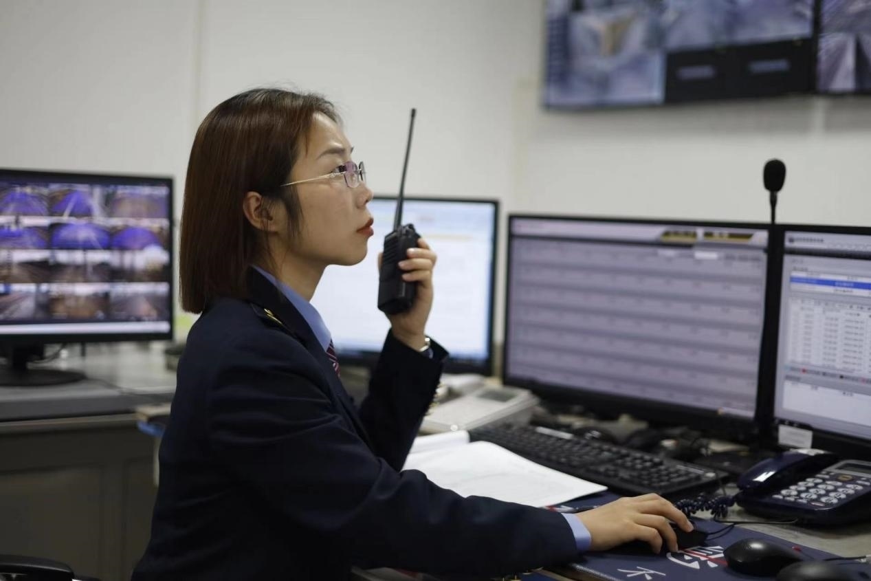 張華正在使用對(duì)講機(jī)溝通客運(yùn)工作情況。蔡紫妍攝