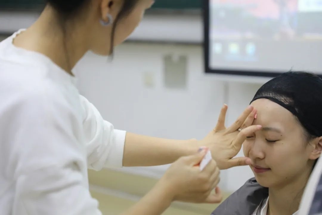 課堂上，一名學生在體驗上戲妝。學校供圖