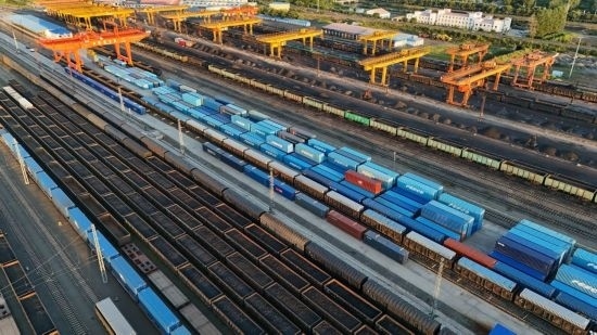 這是2024年8月14日在黑龍江綏芬河鐵路口岸集裝箱換裝場拍攝的集裝箱換裝作業(yè)現(xiàn)場（無人機(jī)照片）。今年前七個月，綏芬河鐵路口岸開行中歐班列573列，運量達(dá)55246標(biāo)箱，同比分別增長23%和18%，班列數(shù)量持續(xù)保持高位運行。