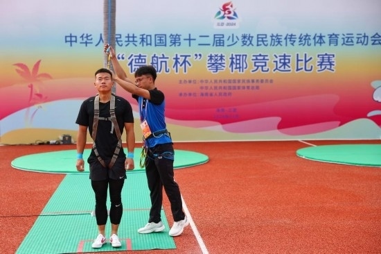 11月23日，工作人員為上海隊選手付樂樂（左）系安全繩。新華社記者 楊植森 攝